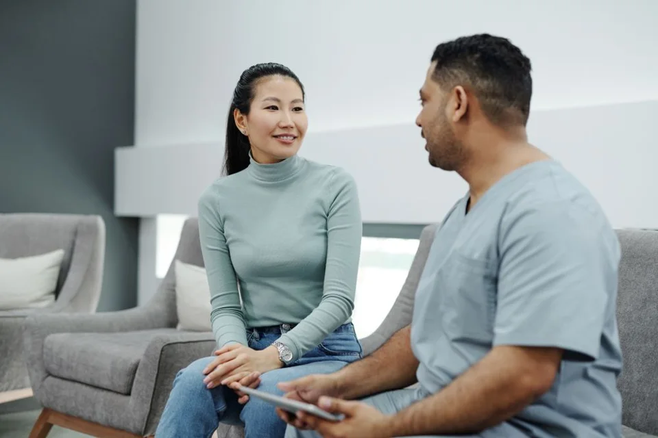A doctor speaking with a patient during a consultation