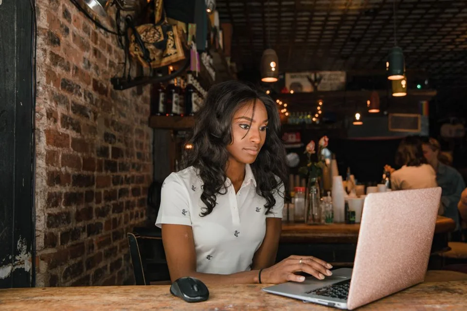 A remote worker using a laptop in a cafe