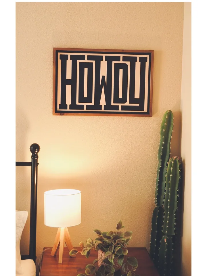 Howdy artwork, cactus and warm lamplight