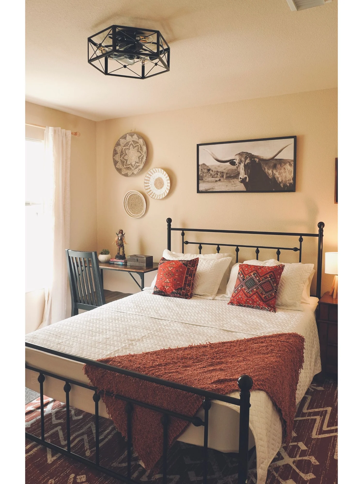 Rawhide No.7 with an iron queen bed, western art and warm red accents